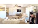 Inviting living room features neutral decor, a ceiling fan, and seamlessly flows to the kitchen at 5533 E Decatur St, Mesa, AZ 85205