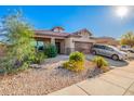 Charming single-story home with a well-manicured desert landscape, covered porch and two car garage at 5625 W Euclid Ave, Laveen, AZ 85339