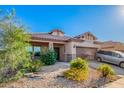 Charming single-story home with a well-manicured desert landscape, covered porch and two car garage at 5625 W Euclid Ave, Laveen, AZ 85339