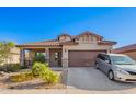 Charming single-story home with a well-manicured desert landscape, covered porch and two car garage at 5625 W Euclid Ave, Laveen, AZ 85339