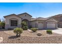 Well-maintained single-story home with desert landscaping, rock accents, and a tile roof at 7329 W Tether Trl, Peoria, AZ 85383