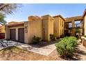 Beautiful condo exterior showcases a private garage, lush landscaping, and a serene setting at 8314 N 21St Dr # K108, Phoenix, AZ 85021