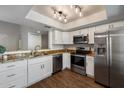 A recently renovated kitchen with stainless steel appliances, granite countertops, and white modern cabinets at 9445 N 94Th Pl # 212, Scottsdale, AZ 85258
