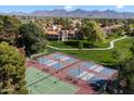 Aerial view of several well-maintained pickleball courts with mountain views in a landscaped community setting at 9445 N 94Th Pl # 212, Scottsdale, AZ 85258