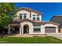 Charming two-story home boasts a welcoming entrance, well-manicured lawn, and an attached two-car garage at 11121 N 165Th Ave, Surprise, AZ 85388