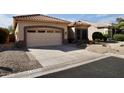 Charming single-story home with a well-maintained lawn and neutral-toned exterior at 11564 W Mule Deer Ct, Surprise, AZ 85378