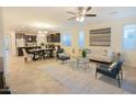 Open-concept living area with tile flooring, modern furnishings, and plenty of natural light at 12030 W Louise Ct, Sun City, AZ 85373