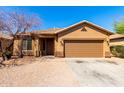 Charming single-story home featuring a two-car garage and a low-maintenance desert landscape at 12218 W Grant St, Avondale, AZ 85323