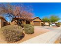 Well-maintained single story home featuring desert landscaping and a two car garage at 12218 W Grant St, Avondale, AZ 85323