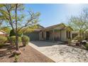 Inviting single-level home with a spacious driveway, desert landscaping, and a cozy covered porch at 12711 W Lowden Rd, Peoria, AZ 85383