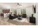 Open-concept living room with modern furnishings, plush seating, and views into the adjacent kitchen area at 12711 W Lowden Rd, Peoria, AZ 85383