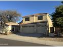 Two-story home with a three-car garage, desert landscaping, and a red tile roof at 1526 E Charleston Ave, Phoenix, AZ 85022