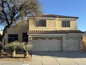 Inviting two-story home with a three-car garage, desert landscaping, and a red tile roof at 1526 E Charleston Ave, Phoenix, AZ 85022