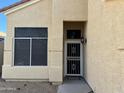 Charming front entryway featuring a secure screen door, light fixture, and well-kept landscaping at 1526 E Charleston Ave, Phoenix, AZ 85022