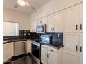 Bright kitchen featuring modern appliances, white cabinets, and dark countertops at 154 W 5Th St # 157, Tempe, AZ 85281