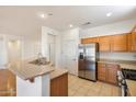 Bright, well-equipped kitchen featuring stainless steel appliances and a breakfast bar at 17661 N Saddle Ridge Dr, Surprise, AZ 85374