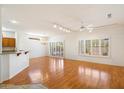 Open-concept living room with hardwood floors and stylish plantation shutters at 17661 N Saddle Ridge Dr, Surprise, AZ 85374