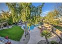 An aerial view shows the beautiful backyard pool with lush landscaping at 188 E Mountain View Rd, San Tan Valley, AZ 85143