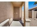 Inviting front porch featuring a security door and neutral stucco columns at 2056 E Saratoga St, Gilbert, AZ 85296