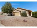 Inviting single-level house with xeriscaping, a two-car garage, and a well-manicured lawn at 2056 E Saratoga St, Gilbert, AZ 85296