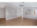 Bright, spacious living room with wood-look floors and a stylish accent wall at 2056 E Saratoga St, Gilbert, AZ 85296