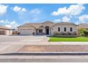 Inviting home exterior featuring manicured lawn and stone accents enhancing its curb appeal at 21921 E Domingo Rd, Queen Creek, AZ 85142