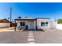 Charming home exterior with a quaint porch and desert landscaping at 2512 N 29Th St, Phoenix, AZ 85008