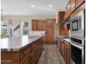 Well-equipped kitchen featuring modern appliances, custom cabinetry, and an expansive island with a sink at 27000 N Alma School Pkwy # 1032, Scottsdale, AZ 85262