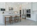 Modern kitchen featuring white cabinetry, stainless steel appliances, a center island, and pendant lighting at 37765 W Santa Maria St, Maricopa, AZ 85138