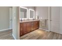 Bathroom featuring a double vanity with lit mirrors and decorative features at 4553 S Alamos Way, Gold Canyon, AZ 85118