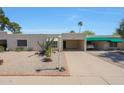 Charming single-story home showcasing desert landscaping, a covered parking space, and a well-maintained facade at 5429 N 78Th St, Scottsdale, AZ 85250