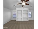 Bright living room featuring vaulted ceilings and built-in shelving at 573 W Rattlesnake Pl, Casa Grande, AZ 85122