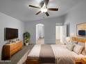 Main bedroom showcasing vaulted ceilings, a ceiling fan, and neutral carpeting at 573 W Rattlesnake Pl, Casa Grande, AZ 85122