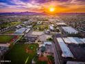 Expansive aerial view showcases the property's desirable location with distant mountains and a vibrant community at sunset at 6018 N 32Nd Ave, Phoenix, AZ 85017