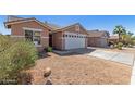 Charming single-story home with a two-car garage, low-maintenance desert landscaping, and a concrete driveway at 6619 W Whyman Ave, Phoenix, AZ 85043