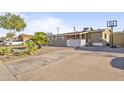 Charming single-story home with a minimalist rock garden and extended driveway at 6627 W Keim Dr, Glendale, AZ 85301