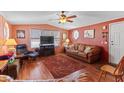 Bright living room with laminate floors, ceiling fan, and comfortable seating at 701 S Dobson Rd # 432, Mesa, AZ 85202