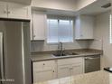 Updated kitchen featuring white cabinets, stainless steel appliances, tile backsplash and granite countertops at 850 S River Dr # 2018, Tempe, AZ 85281