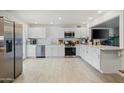 Bright, updated kitchen featuring stainless steel appliances, white cabinets, and tile backsplash at 901 E Rose Ln, Phoenix, AZ 85014