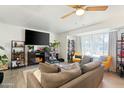 Cozy living room with a comfortable gray sofa, stylish bookshelves, and neutral decor at 901 E Rose Ln, Phoenix, AZ 85014