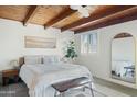 Bright main bedroom with vaulted wood ceilings, white walls, and a decorative rug at 901 E Rose Ln, Phoenix, AZ 85014