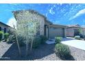 Attractive single-story home with stone veneer, lush front yard and a two-car garage at 9413 W Devonshire Ave, Phoenix, AZ 85037