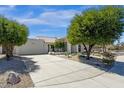 Home with a long driveway, attached garage, desert landscaping, and a well-manicured lawn at 10013 N 106Th Pl, Scottsdale, AZ 85258