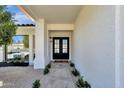 Close-up of the front door with black frame, and desert landscaping at 10013 N 106Th Pl, Scottsdale, AZ 85258