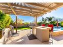 Backyard featuring a built in outdoor kitchen, grill, and bar perfect for entertaining and outdoor enjoyment at 12055 W Nadine Way, Peoria, AZ 85383