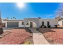 Charming single-story home with an arched entryway and well-maintained front yard at 13008 N 28Th Pl, Phoenix, AZ 85032