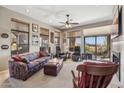 Bright living room featuring comfortable seating, fireplace, and sliding glass door to balcony at 13013 N Panorama Dr # 120, Fountain Hills, AZ 85268
