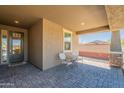 Covered patio with tiled flooring offering a cozy seating area, perfect for relaxing outdoors at 13455 N 142Nd Ave, Surprise, AZ 85379