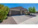 Charming single-story home with a desert front yard, a two-car garage, and a welcoming entrance at 13455 N 142Nd Ave, Surprise, AZ 85379