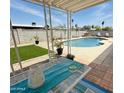 Inviting backyard with a sparkling pool, patio, and well manicured turf at 14803 N 55Th Ave, Glendale, AZ 85306